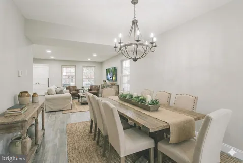a view of a dining room with furniture wooden floor and chandelier