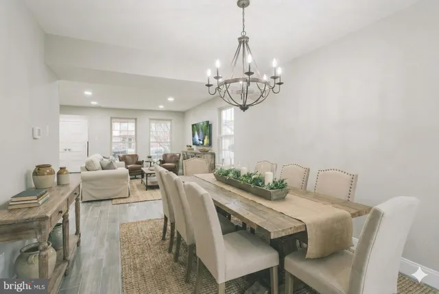 a view of a dining room with furniture wooden floor and chandelier