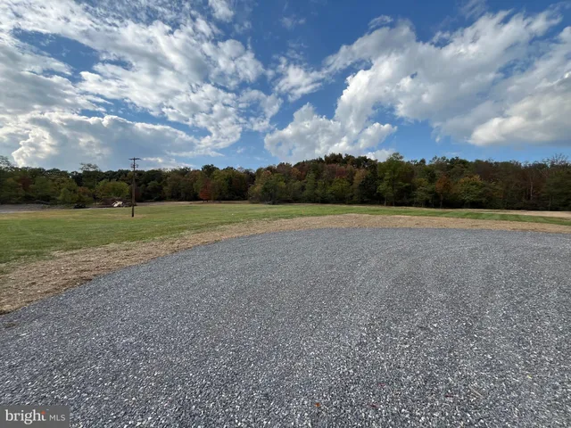 a view of a field with an trees in the background