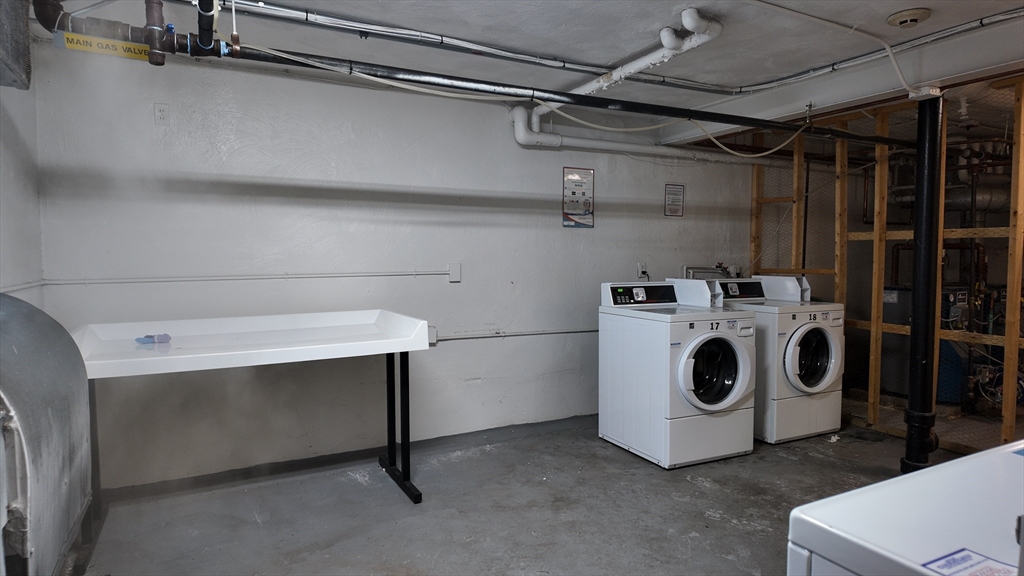 99 Cluff Crossing Road, Unit E9 Salem, NH 03079 - Photo 13 of 13 a utility room with dryer and washer