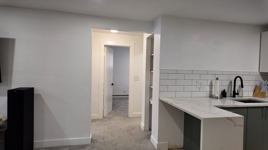 99 Cluff Crossing Road, Unit E9 Salem, NH 03079 - Photo 4 of 13 a kitchen with a sink and a refrigerator