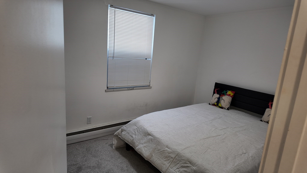 99 Cluff Crossing Road, Unit E9 Salem, NH 03079 - Photo 8 of 13 a bedroom with a bed and a window