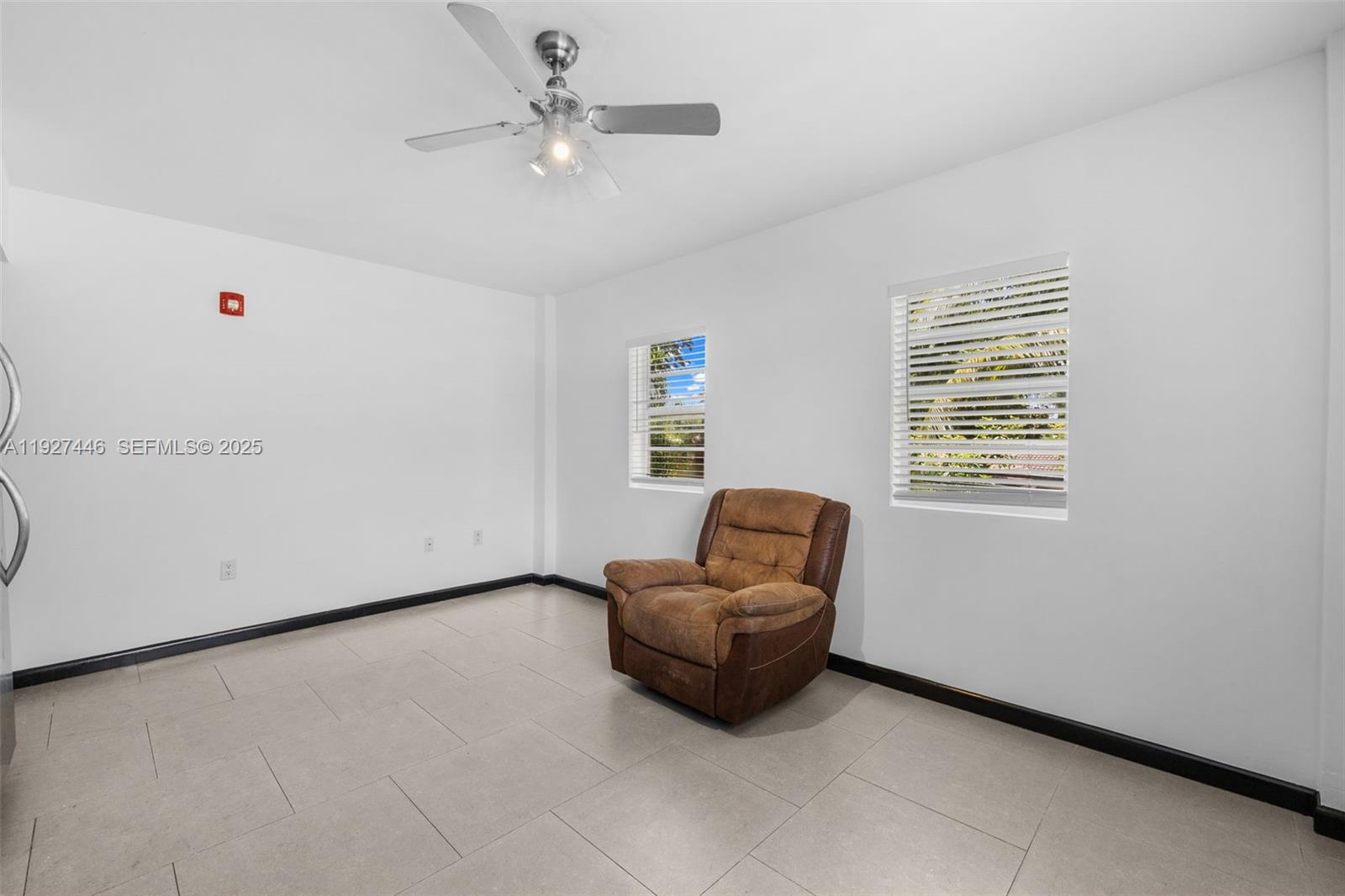 1876 Southwest 11th Terrace, Unit 206 Miami, FL 33135 - Photo 8 of 15 a living room with furniture and a window