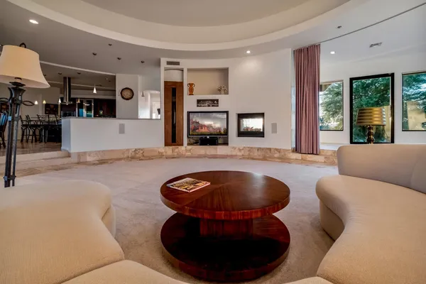 a living room with furniture and a floor to ceiling window