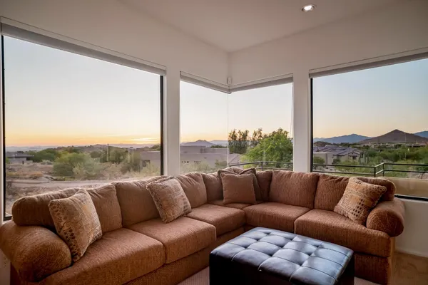 a living room with furniture and a mountain view