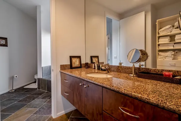 a front view of a house with a yard and mountain view in back