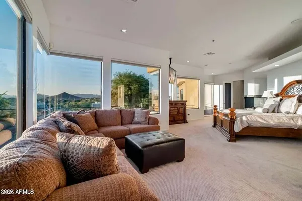 a bedroom with a bed and a television