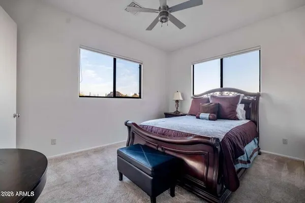 a bed sitting in a bedroom next to a window