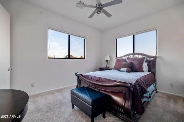 a bed sitting in a bedroom next to a window