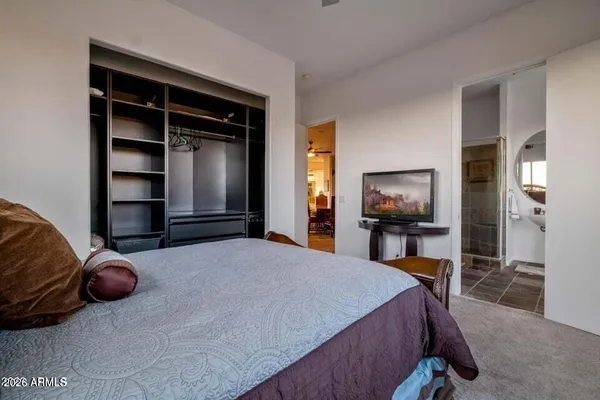 a bedroom with a bed and a large window