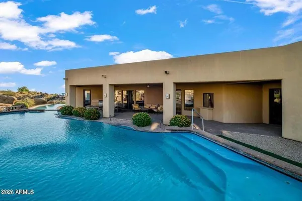 a view of a house with backyard sitting area and garden