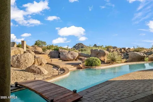 a view of a backyard with plants and a patio