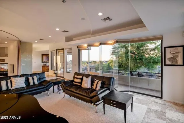 a living room with furniture and a floor to ceiling window