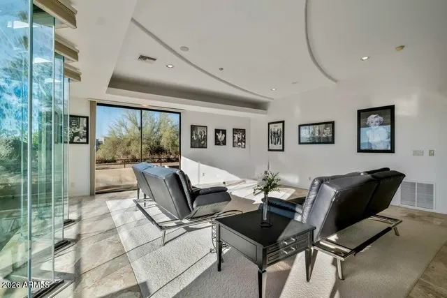 a view of a balcony with floor to ceiling window next to a yard