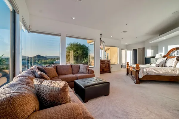 a bed sitting in a bedroom next to a window