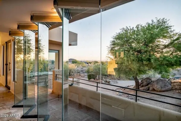 a living room with furniture a window and a potted plant