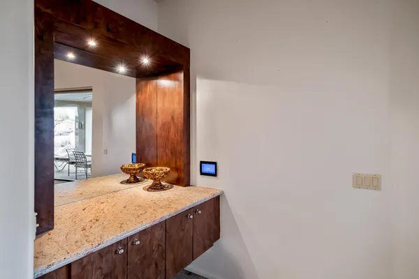 a bathroom with a granite countertop sink and a mirror