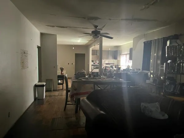 a view of dining room and livingroom with furniture wooden floor a rug and a chandelier