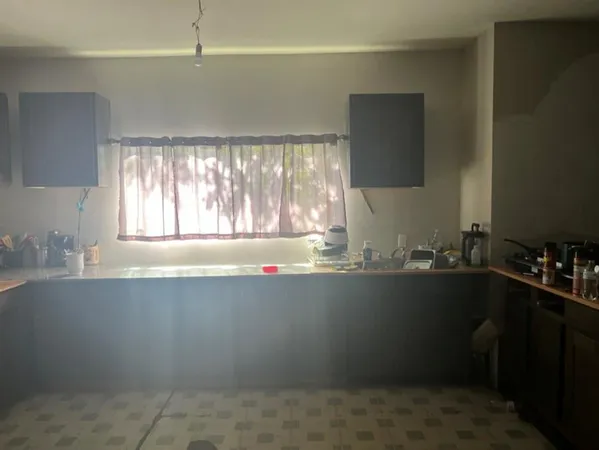 a kitchen with a sink a window and cabinets