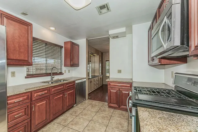 a kitchen with a sink stove and cabinets