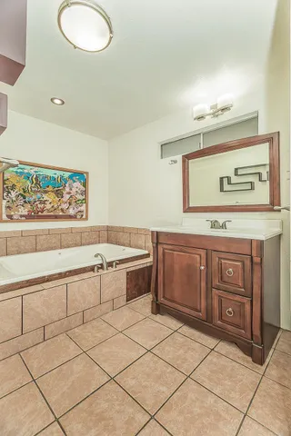 a spacious bathroom with a vanity a sink and a mirror