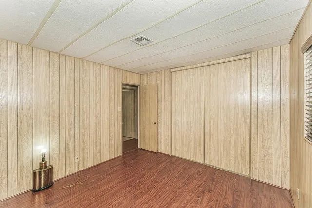 a view of a room with wooden floor