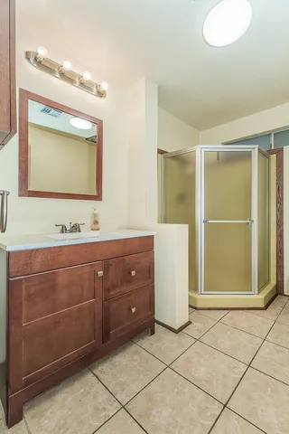 a bathroom with a sink vanity and mirror