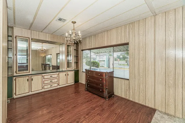 a large kitchen with a wooden floor and cabinets