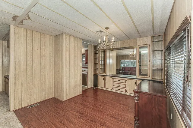 a view of a refrigerator in kitchen and wooden floor