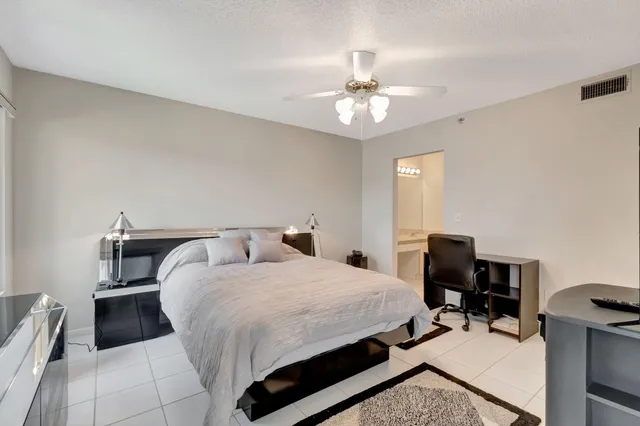 a bedroom with a bed and a table chair