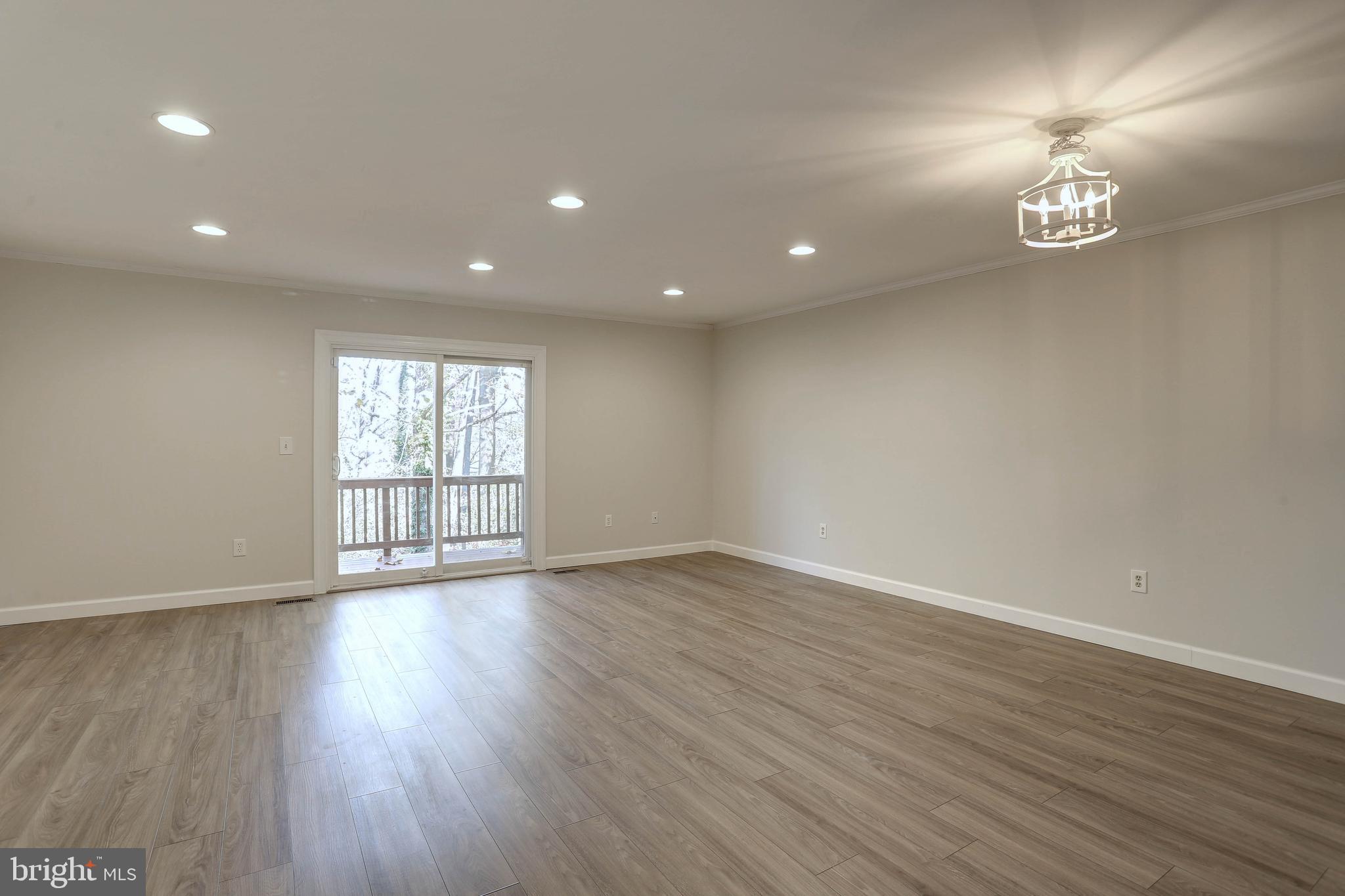 20 Bryans Mill Way Baltimore, MD 21228 - Photo 12 of 36 a view of an empty room with wooden floor and a window
