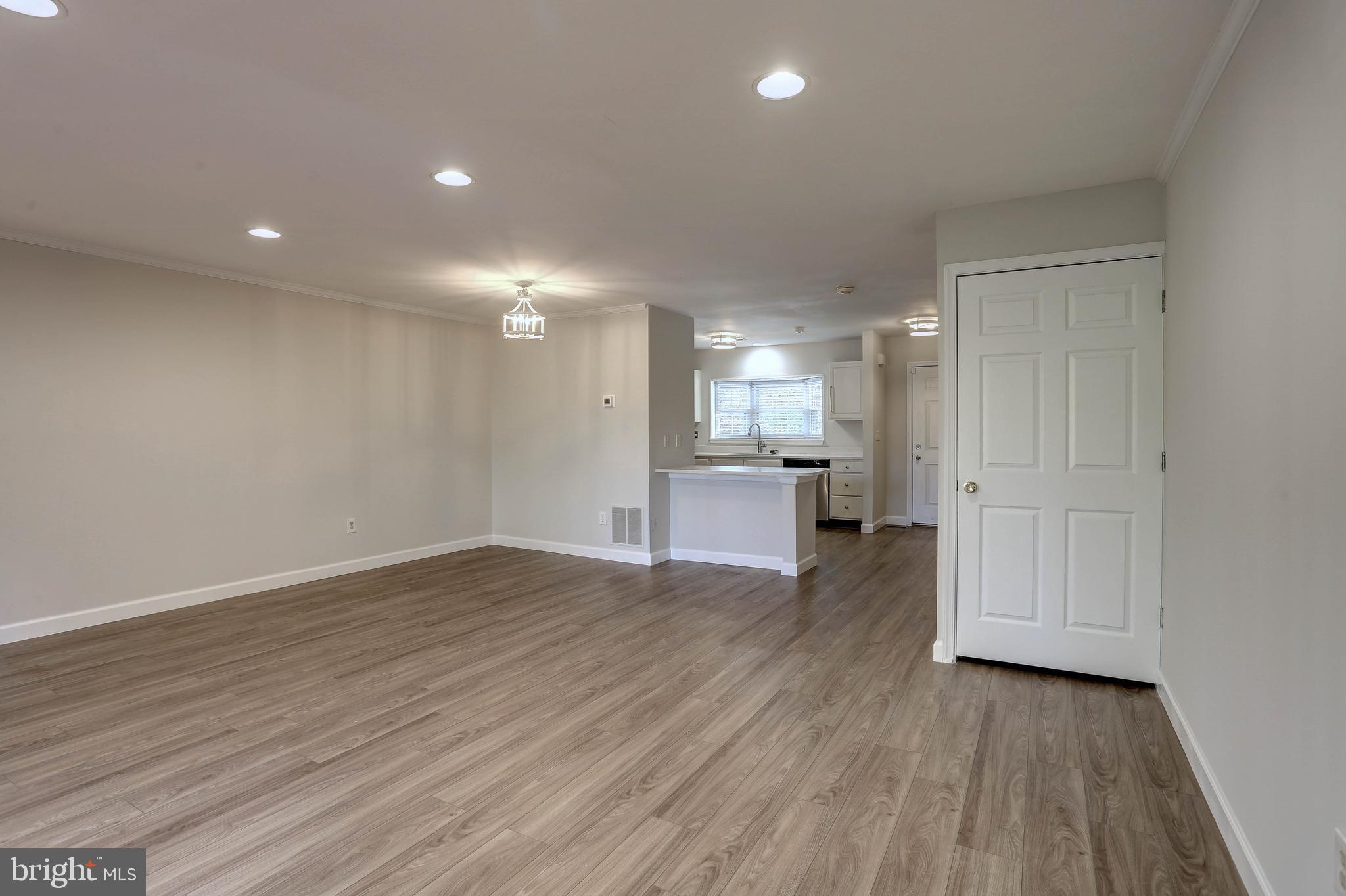 20 Bryans Mill Way Baltimore, MD 21228 - Photo 14 of 36 a view of a kitchen with wooden floor and a sink