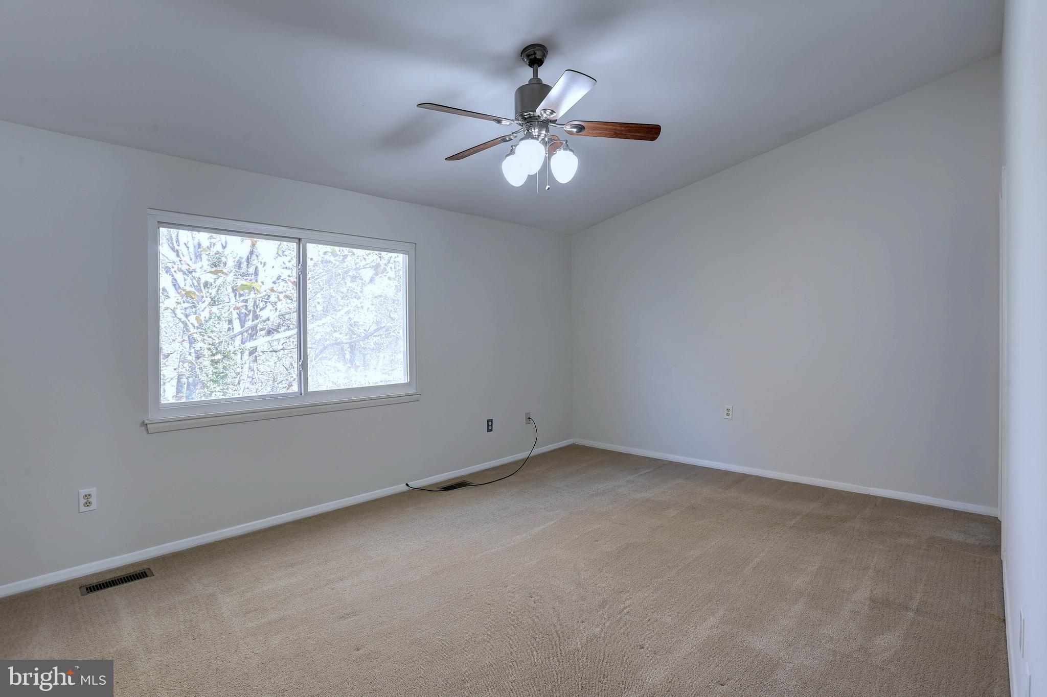 20 Bryans Mill Way Baltimore, MD 21228 - Photo 18 of 36 an empty room with a window and a fan