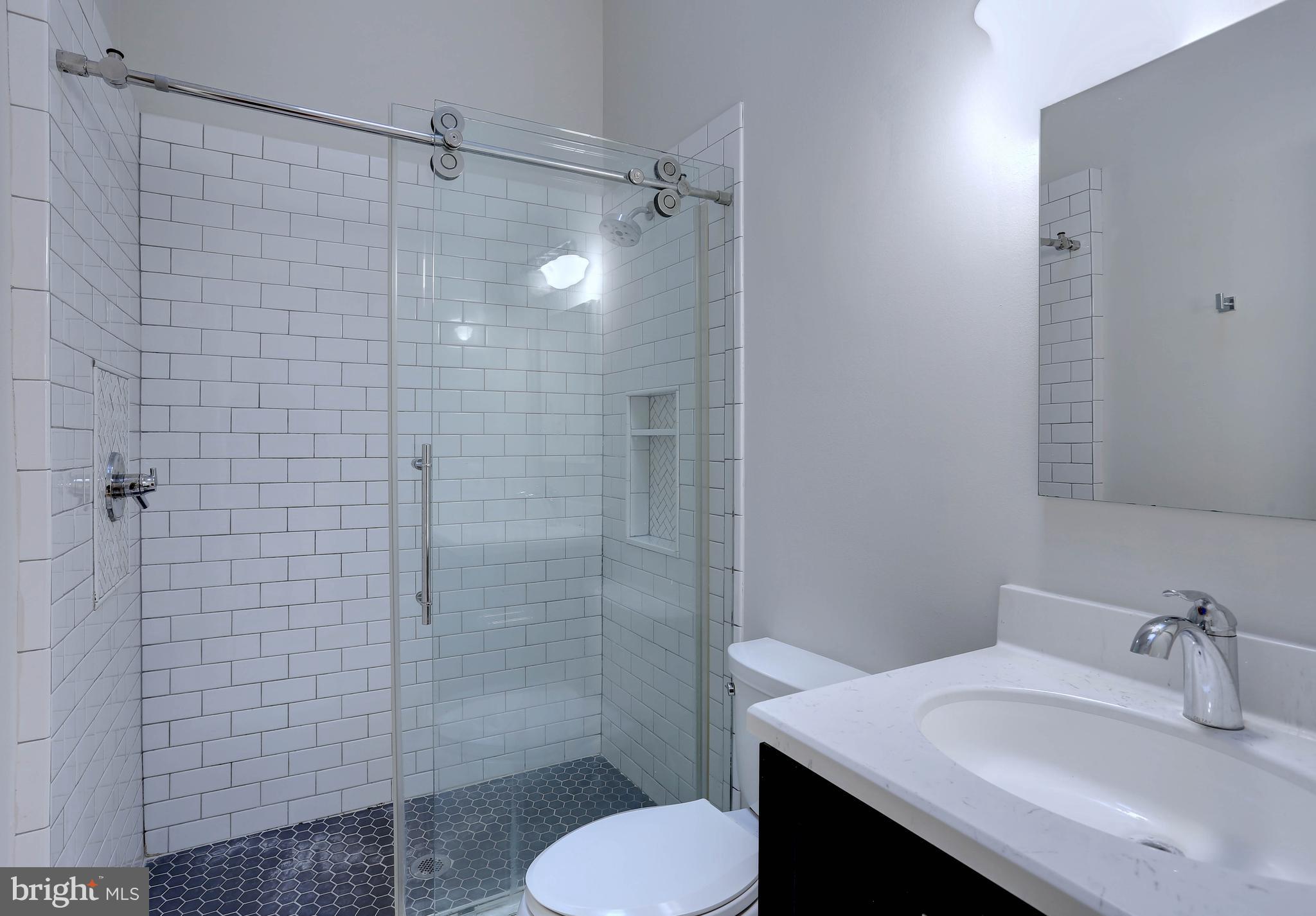 20 Bryans Mill Way Baltimore, MD 21228 - Photo 19 of 36 a bathroom with a sink toilet and shower