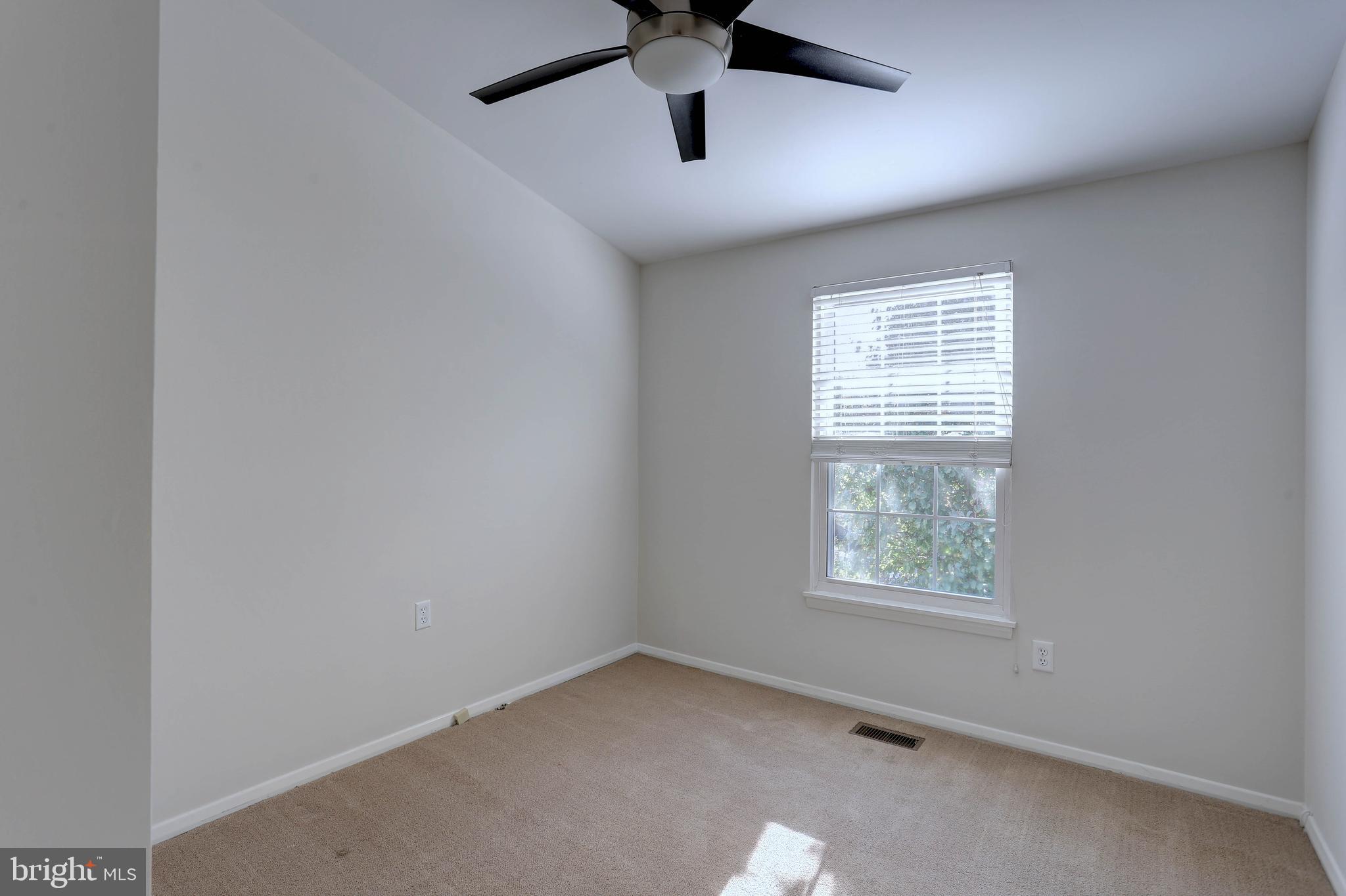 20 Bryans Mill Way Baltimore, MD 21228 - Photo 24 of 36 an empty room with a window and a fan