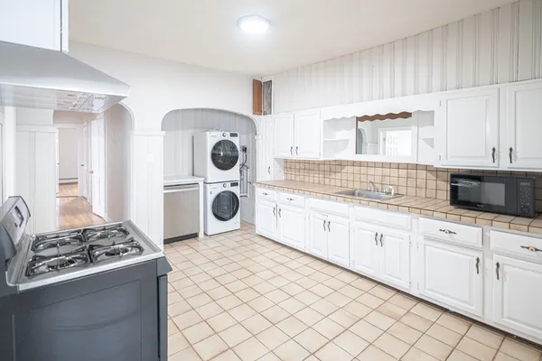 a kitchen with stainless steel appliances granite countertop a stove and a sink