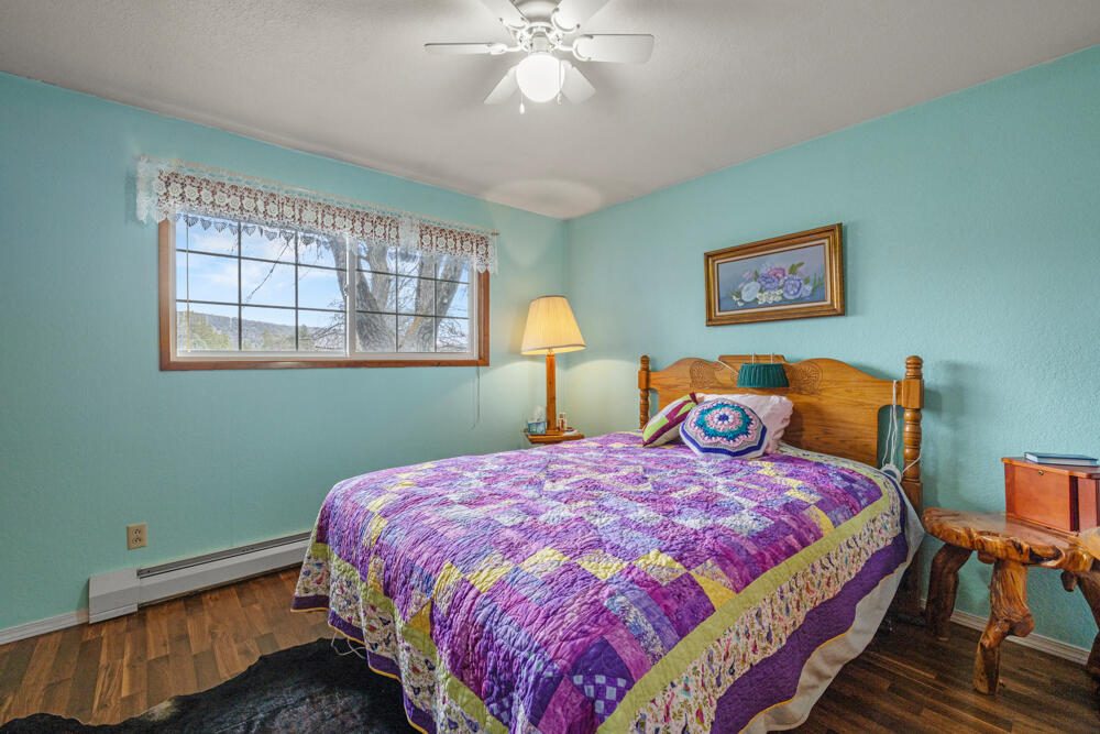 47477 Gerber Road Bonanza, OR 97623 - Photo 49 of 63 a bedroom with a bed and a chandelier