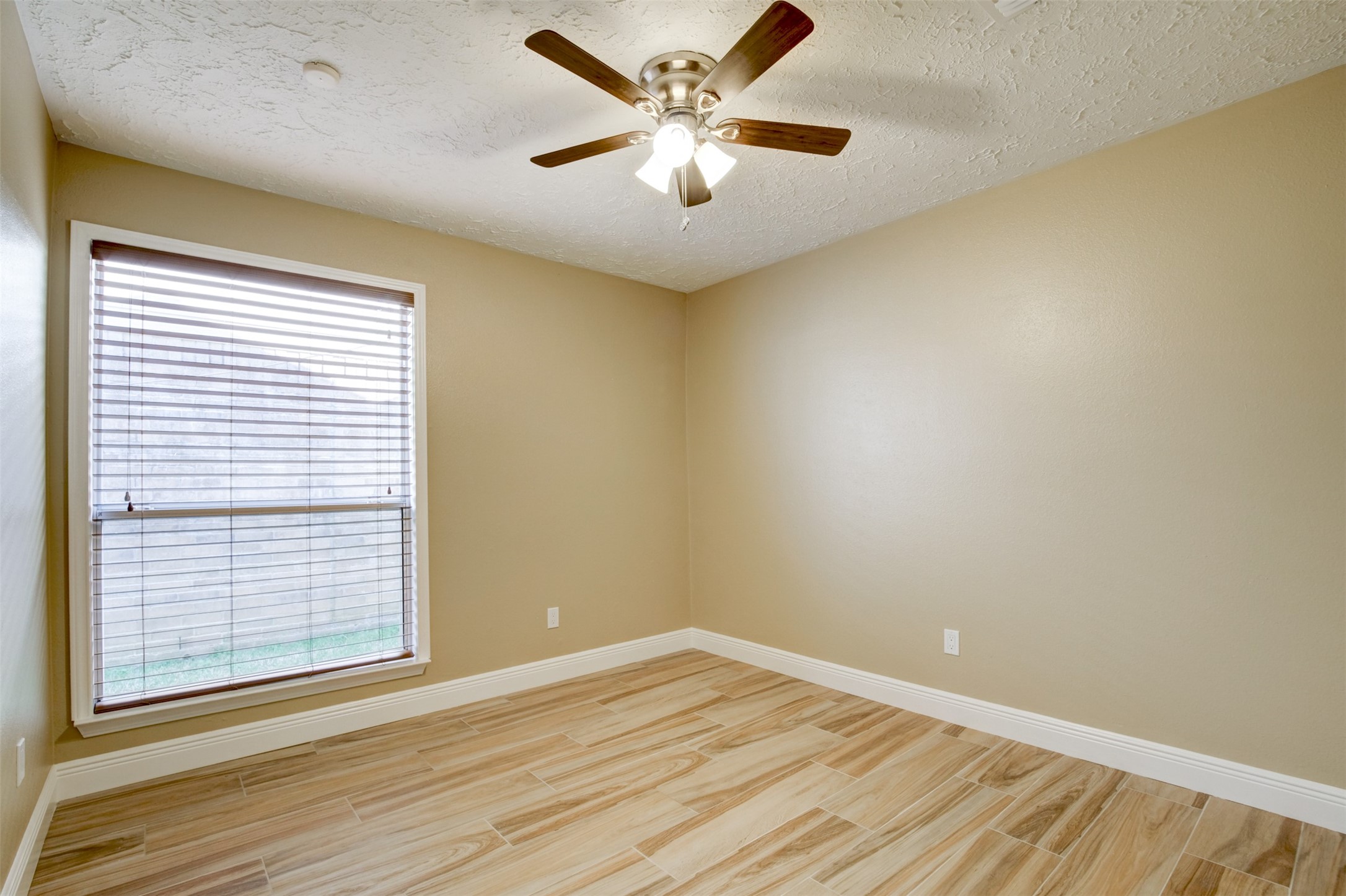 11840 Spring Grove Drive Houston, TX 77099 - Photo 21 of 27 Spacious secondary bedroom with ceiling fan and beautiful wood llooking flooring