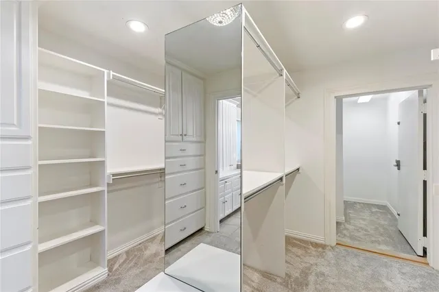 an empty room with wooden floor ceiling fan and windows