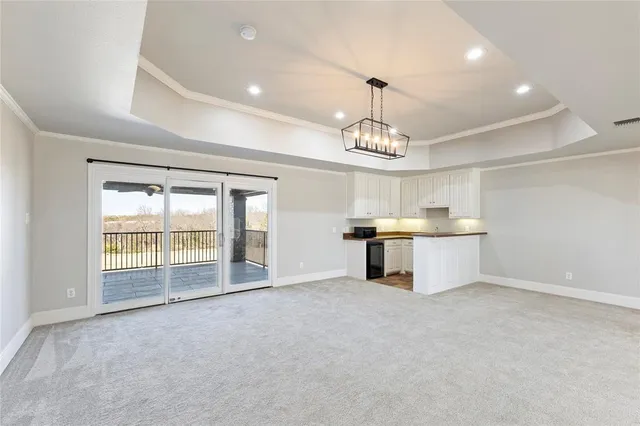 a view of a kitchen with a sink and chandelier