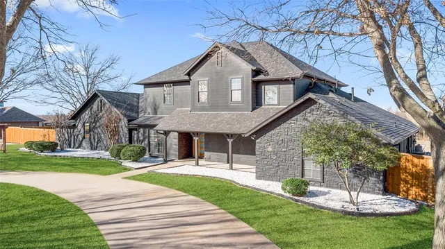 a front view of a house with a yard table and chairs