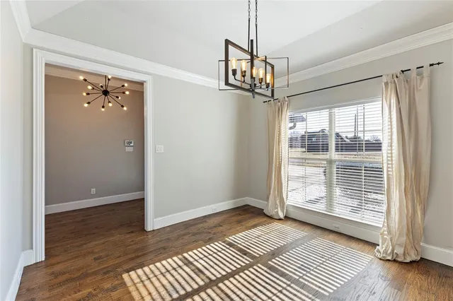 a view of a hallway with wooden floor and a ceiling fan