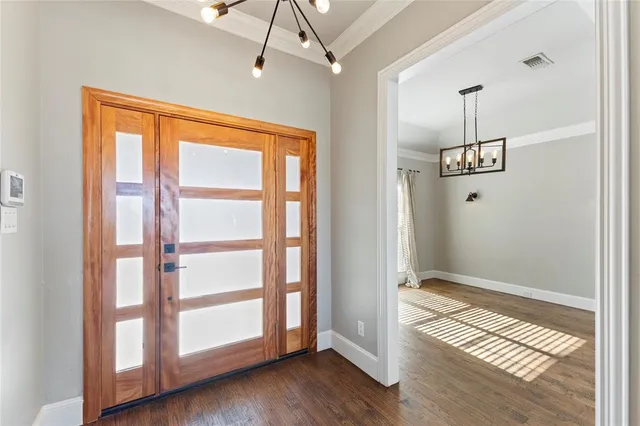 a view of an entryway with wooden floor