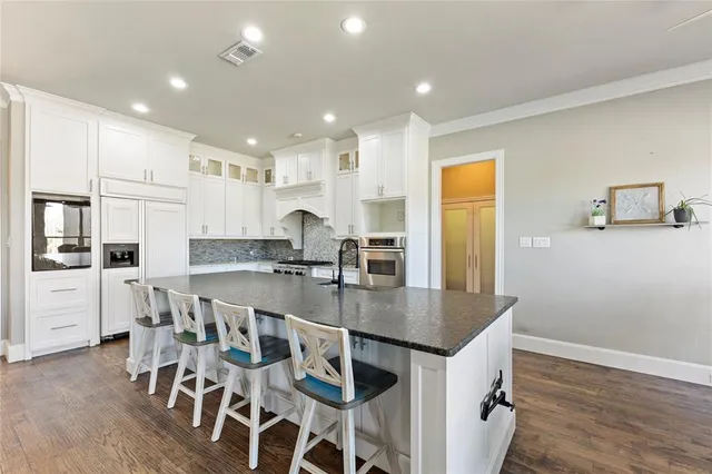 a large kitchen with a table and chairs