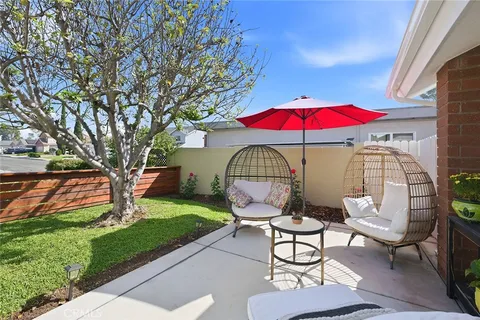 a patio with a table and chairs under an umbrella