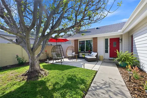 a front view of a house with garden and patio