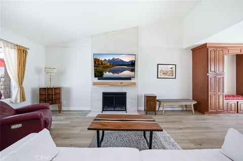 a living room with furniture a fireplace and windows