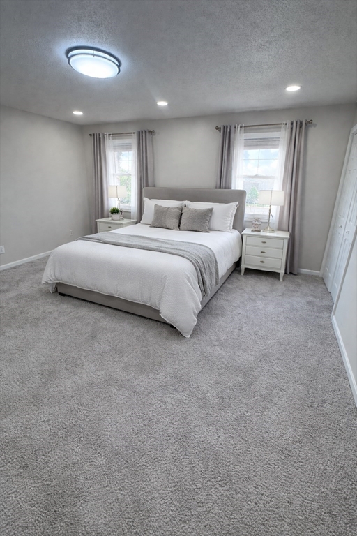 200 Lambert Terrace, Unit 41 Chicopee, MA 01020 - Photo 15 of 24 a spacious bedroom with a bed and a large window