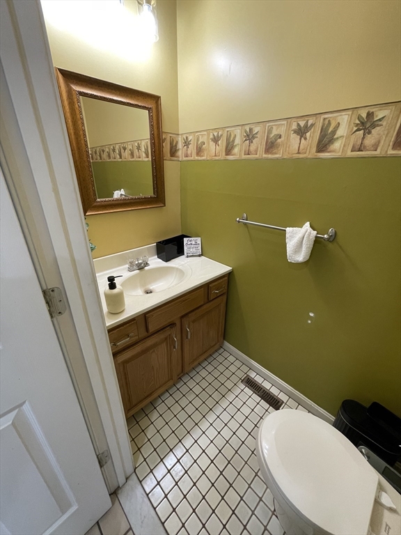 200 Lambert Terrace, Unit 41 Chicopee, MA 01020 - Photo 9 of 24 a bathroom with a sink a toilet and mirror
