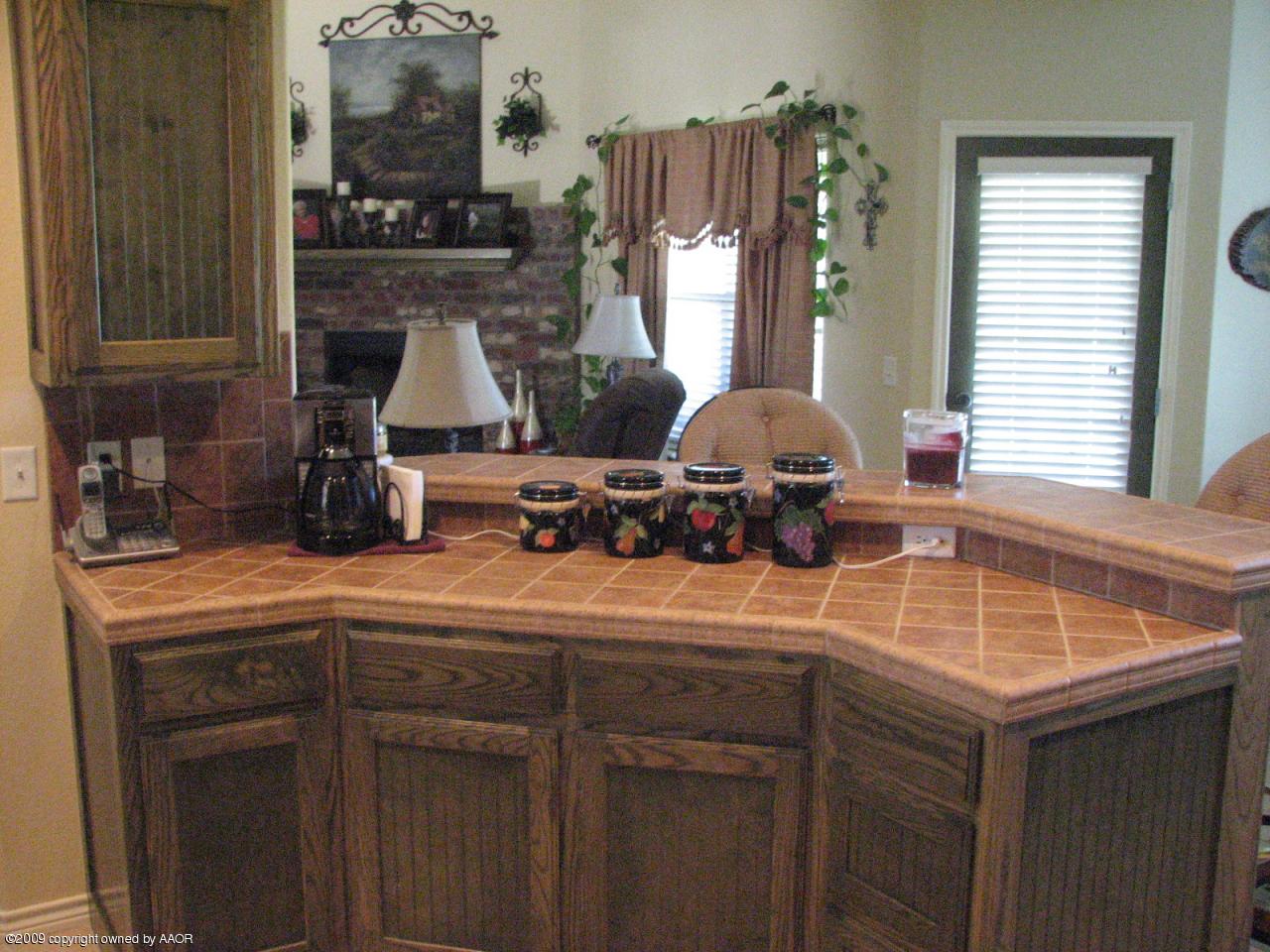 6602 Slater Circle Amarillo, TX 79110 - Photo 11 of 25 a kitchen with a sink cabinets and window